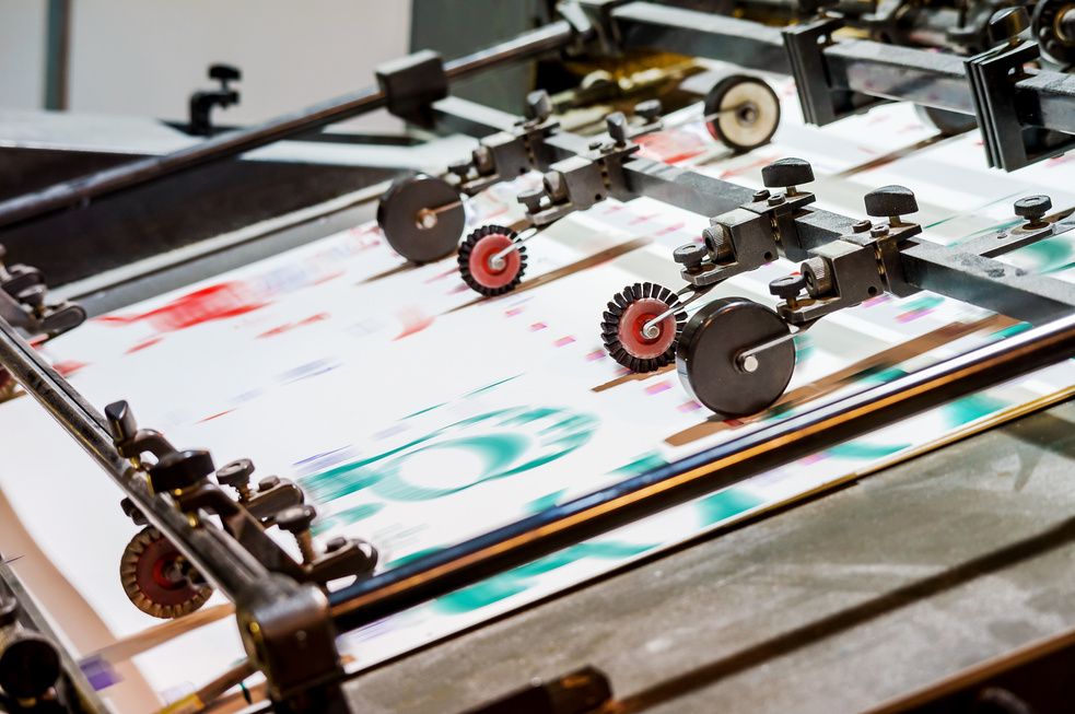 Finishing machine processing printed sheets
